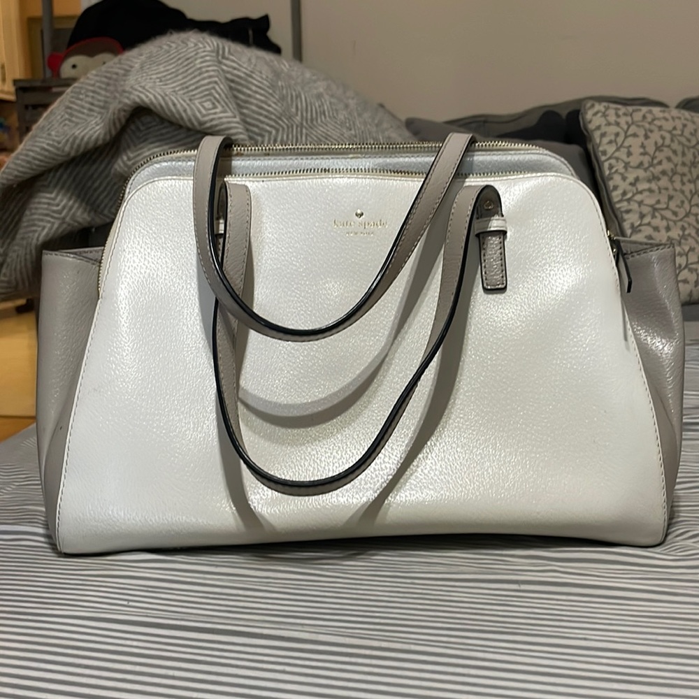 Large cream and light tan Kate spade purse. It’s huge lots of room and pockets!